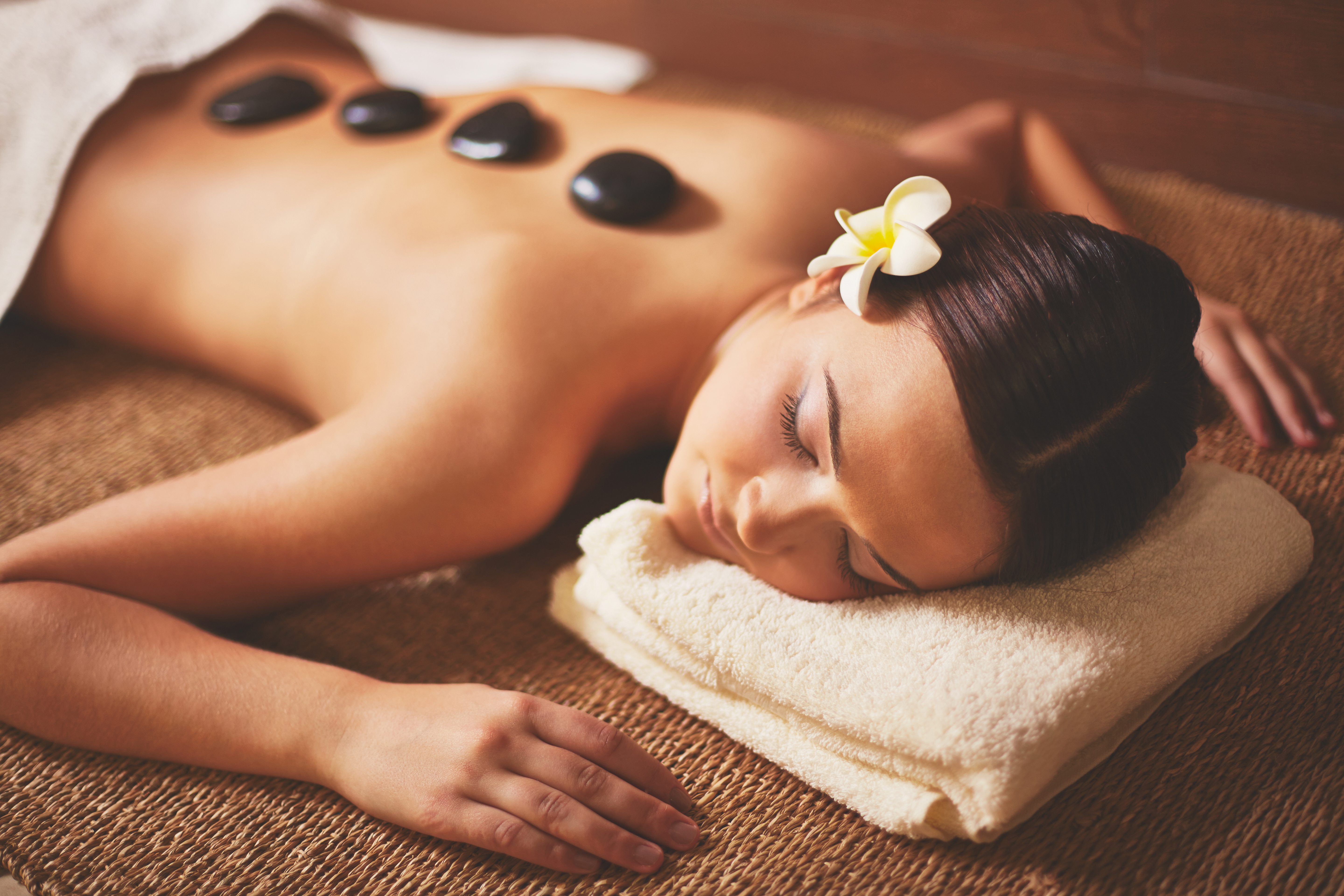 young woman receiving hot stone massage